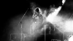 Black and white photo of musician on stage